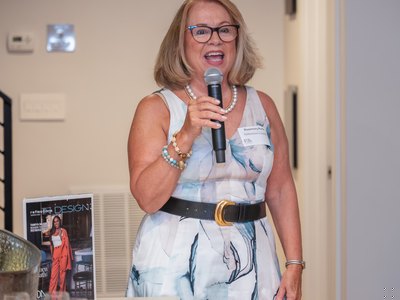A guest addressing the room, microphone in hand