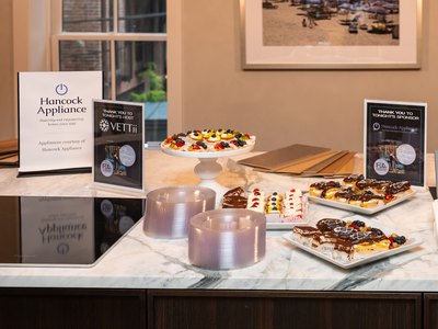 The tapas laid out along the counter, under the evening's signage