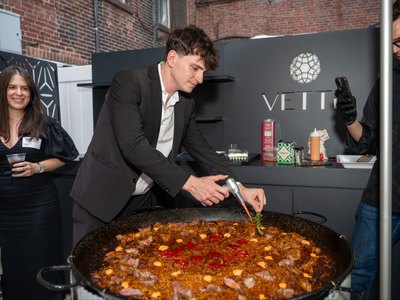 The paella worked with a long spoon as the rice takes up the stock