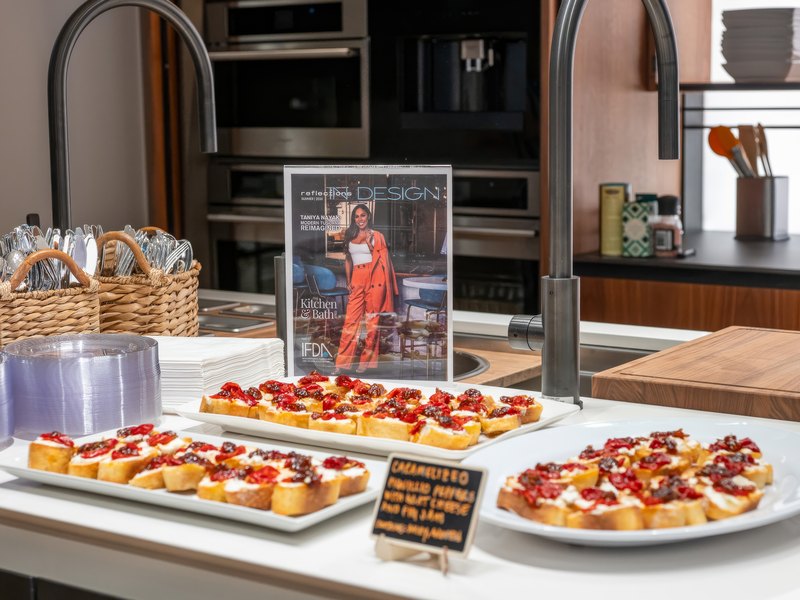 Spanish tapas plated along a VETTii counter, with the summer issue standing open behind them