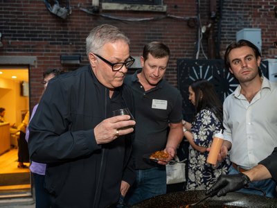 Guests with drinks in hand as the evening goes on